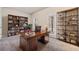 The dedicated office space is furnished with a large desk, bookshelves, and natural light at 6404 Brookside Se Blvd, Mableton, GA 30126