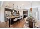 Elegant kitchen featuring a large island with seating, stainless appliances, and modern lighting at 6404 Brookside Se Blvd, Mableton, GA 30126