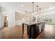 Spacious kitchen features a large island with stainless steel appliances and elegant pendant lighting at 6404 Brookside Se Blvd, Mableton, GA 30126
