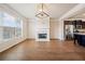 Open living area with hardwood floors, a fireplace, and a view into the kitchen at 6404 Brookside Se Blvd, Mableton, GA 30126