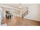 Spacious open floor plan with hardwood flooring connecting the living area, kitchen, and staircase at 6404 Brookside Se Blvd, Mableton, GA 30126