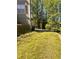 An expansive backyard with mature trees and an overgrown lawn at 7027 Grinder Drive, Austell, GA 30168