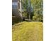 An expansive backyard with mature trees and an overgrown lawn at 7027 Grinder Drive, Austell, GA 30168