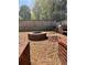 Outdoor entertaining area with a brick fire pit, stone ground cover, and built-in grilling station at 7027 Grinder Drive, Austell, GA 30168