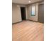 Bedroom featuring wood laminate flooring, neutral walls, and a window at 7027 Grinder Drive, Austell, GA 30168