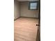 Bedroom featuring wood laminate flooring, neutral walls, and a window at 7027 Grinder Drive, Austell, GA 30168