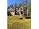 Two-story home with stone facade, two-car garage, and mature landscaping at 7027 Grinder Drive, Austell, GA 30168