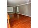 Living room featuring hardwood floors, a large window, and neutral wall colors at 7027 Grinder Drive, Austell, GA 30168