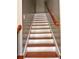 Carpetless staircase with light risers and wood treads and railing at 7027 Grinder Drive, Austell, GA 30168