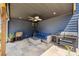 Relaxing outdoor living space with comfortable seating, ceiling fan, and outdoor kitchen at 2111 Harmony Dr, Canton, GA 30115