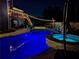 A relaxing backyard view at night featuring a luminous pool, spa, and string lights creating a magical ambiance at 2111 Harmony Dr, Canton, GA 30115