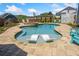 Stunning backyard pool with in-pool loungers, tanning ledge, and lush landscaping at 2111 Harmony Dr, Canton, GA 30115