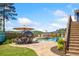 Gorgeous backyard with a sparkling pool, stone patio, dining area, and lush landscaping at 2111 Harmony Dr, Canton, GA 30115