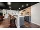 Basement bar with granite countertops, tile backsplash, bar stools, and custom wine rack shelves at 2111 Harmony Dr, Canton, GA 30115