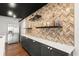 Close-up of basement bar area with custom tile backsplash, countertops, wine rack and shelving for alcohol at 2111 Harmony Dr, Canton, GA 30115