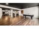 Large open basement with a pool table, bar area, hardwood floors and dark ceiling at 2111 Harmony Dr, Canton, GA 30115