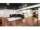 Open basement area with hardwood floors, a large comfy couch and a dark ceiling at 2111 Harmony Dr, Canton, GA 30115