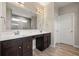 Luxurious bathroom with dual sinks, dark wood cabinetry, and a large framed mirror at 2111 Harmony Dr, Canton, GA 30115