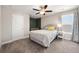 Well-lit bedroom featuring a ceiling fan, neutral walls, plush carpeting and a large sunny window at 2111 Harmony Dr, Canton, GA 30115