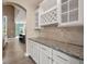 Elegant butler's pantry with granite countertops, custom cabinets, and wine storage at 2111 Harmony Dr, Canton, GA 30115