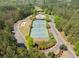 A beautiful aerial view of community amenities including tennis courts, playground and pool at 2111 Harmony Dr, Canton, GA 30115