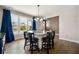 Bright dining area features a stylish light fixture and seating by a large window at 2111 Harmony Dr, Canton, GA 30115