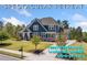 Stately two-story home with manicured lawn, mature trees, charming front porch, and inviting curb appeal at 2111 Harmony Dr, Canton, GA 30115