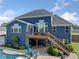 An outdoor living space featuring an elevated deck that offers room for entertaining and relaxing with a pool at 2111 Harmony Dr, Canton, GA 30115
