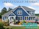 Beautiful two-story blue home featuring stone accents, white trim and lush landscaping at 2111 Harmony Dr, Canton, GA 30115