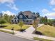Beautiful home with a lush lawn, mature trees, and a long driveway leading to the garage at 2111 Harmony Dr, Canton, GA 30115