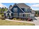 Charming two-story home with a blue exterior, well-manicured lawn, and stone accents at 2111 Harmony Dr, Canton, GA 30115