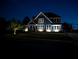 An enchanting front view of a house illuminated at night, showcasing its architectural details and manicured lawn at 2111 Harmony Dr, Canton, GA 30115