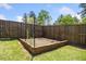 Fenced garden bed, perfect for growing vegetables or flowers, in a sunny backyard setting at 2111 Harmony Dr, Canton, GA 30115