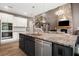 Open-concept kitchen with granite island, stainless steel appliances, and view of the living room at 2111 Harmony Dr, Canton, GA 30115