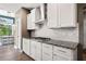 Modern kitchen with granite countertops, white cabinets, and stainless steel appliances at 2111 Harmony Dr, Canton, GA 30115