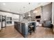 Open-concept kitchen with granite island, stainless steel appliances, and stone fireplace nearby at 2111 Harmony Dr, Canton, GA 30115