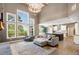 An open-concept living room with large windows and elegant furnishings flows into the kitchen at 2111 Harmony Dr, Canton, GA 30115