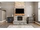 Spacious living room features a stone fireplace, modern cabinets, and wood flooring at 2111 Harmony Dr, Canton, GA 30115