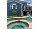 Backyard view featuring a lovely pool with a hot tub, a charming lounge area, and a well-kept garden at 2111 Harmony Dr, Canton, GA 30115