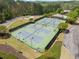 Aerial view of the community tennis courts surrounded by lush greenery and parking at 2111 Harmony Dr, Canton, GA 30115