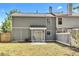 Backyard view of the gray siding, patio, fenced-in yard and mature trees at 2998 Kenville Ln, Decatur, GA 30034