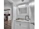 Charming bathroom with a white vanity, granite countertop, framed mirror and decorative accents at 2998 Kenville Ln, Decatur, GA 30034