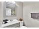 Bathroom with white vanity, decorative framed mirror, and a toilet with matching towel rack at 2998 Kenville Ln, Decatur, GA 30034