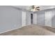 Bedroom with carpet, soft blue walls, ceiling fan and multiple closets for storage at 2998 Kenville Ln, Decatur, GA 30034