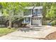 Charming two-story home with blue accents, attached garage, and mature trees surrounding the property at 2998 Kenville Ln, Decatur, GA 30034