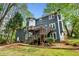 Backyard of home featuring a large wooden deck, stairs, mature trees, and green lawn at 3522 Evans Ridge Trl, Atlanta, GA 30340
