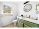 Modern bathroom with updated mirror, vanity, sink, gold fixtures, and natural lighting at 3522 Evans Ridge Trl, Atlanta, GA 30340