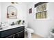 Bathroom featuring a black vanity, gold mirror, modern fixtures, and a large window with wooded views at 3522 Evans Ridge Trl, Atlanta, GA 30340