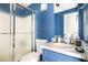 A blue bathroom with a glass enclosed shower and updated vanity at 3522 Evans Ridge Trl, Atlanta, GA 30340