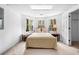 Cozy bedroom with a queen bed, three windows overlooking the backyard, and a matching side table at 3522 Evans Ridge Trl, Atlanta, GA 30340